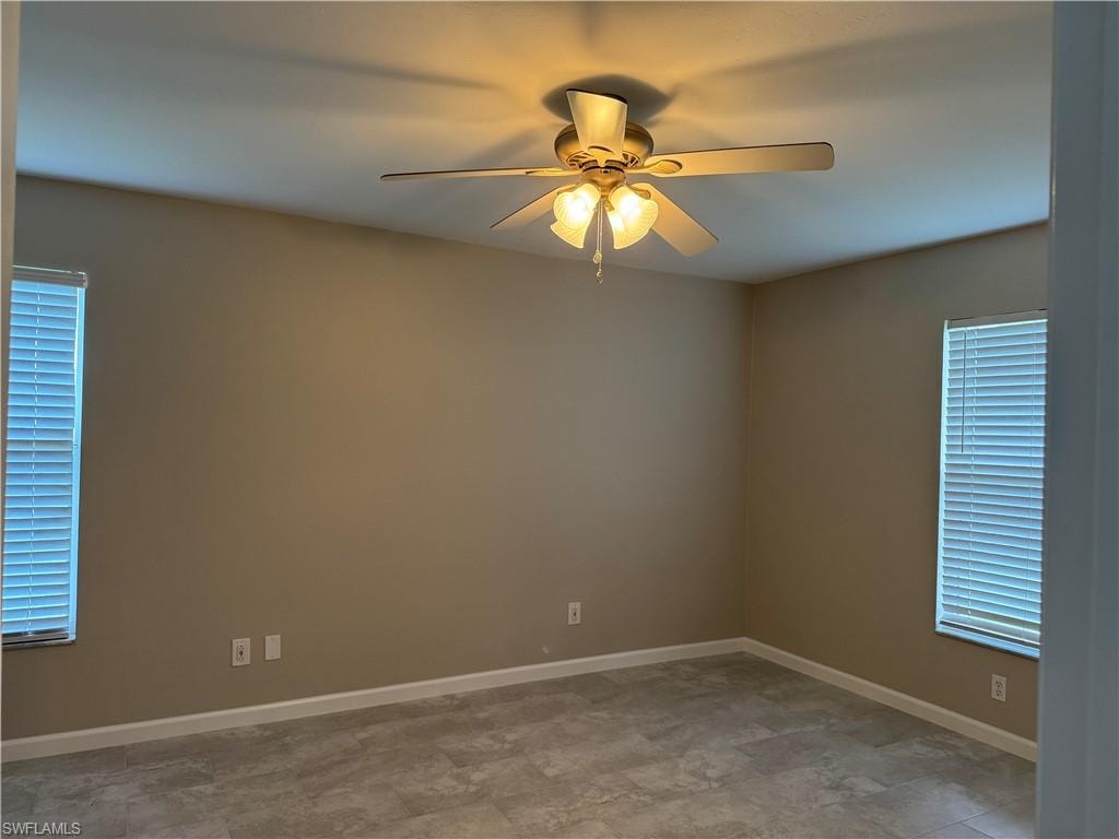 Primary bedroom with new ceiling fan and plenty of natural light with 2 big windows