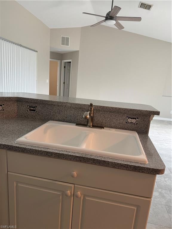 Kitchen featuring dark countertops and vaulted ceiling