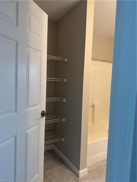 View of shelving in second bath for bathroom linens