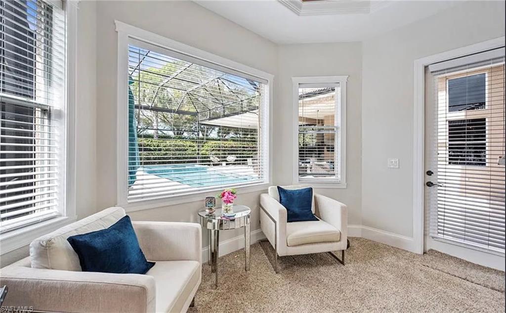 Multiple windows, glass panel door, and plush carpet
