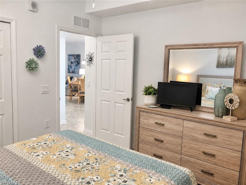 Recessed ceiling speaker, overhead light fixture, white interior doors, and light-toned wall paint