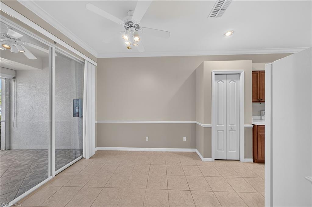 Kitchen dining area with sliding glass door leading out to front screened in porch