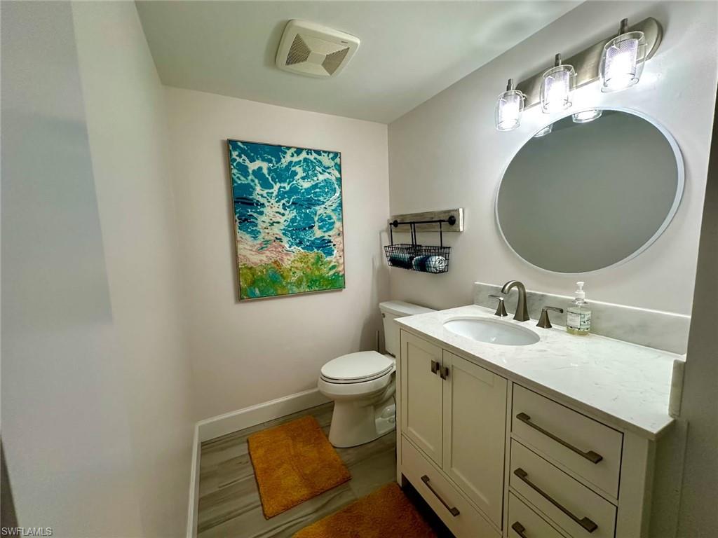 Half bathroom with vanity and gorgeous flooring