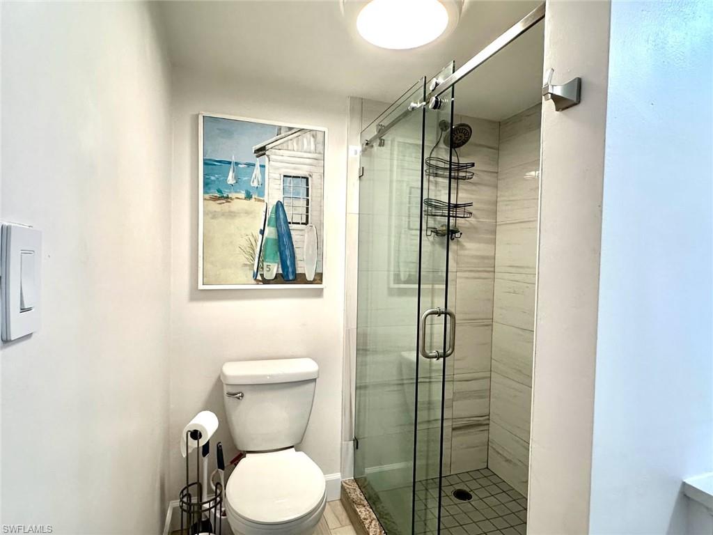 Seamless shower door in walk-in tiled shower room