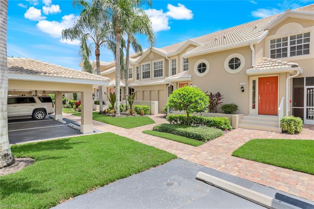 Mediterranean / spanish-style home with stucco siding, a tile roof, and a front yard