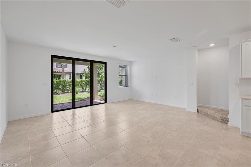 Unfurnished room featuring light tile patterned floors, recessed lighting, and baseboards