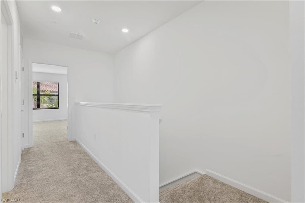 Corridor featuring carpet, baseboards, an upstairs landing, and recessed lighting