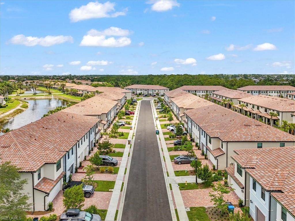 Aerial perspective of suburban area featuring a nearby body of water