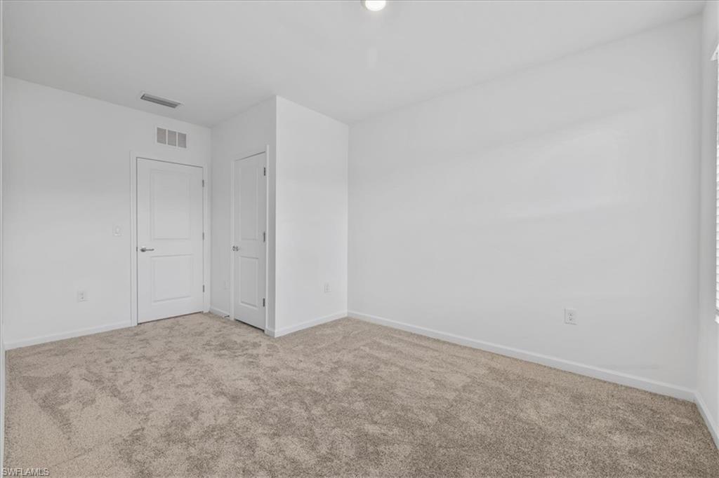 Spare room with carpet floors and baseboards