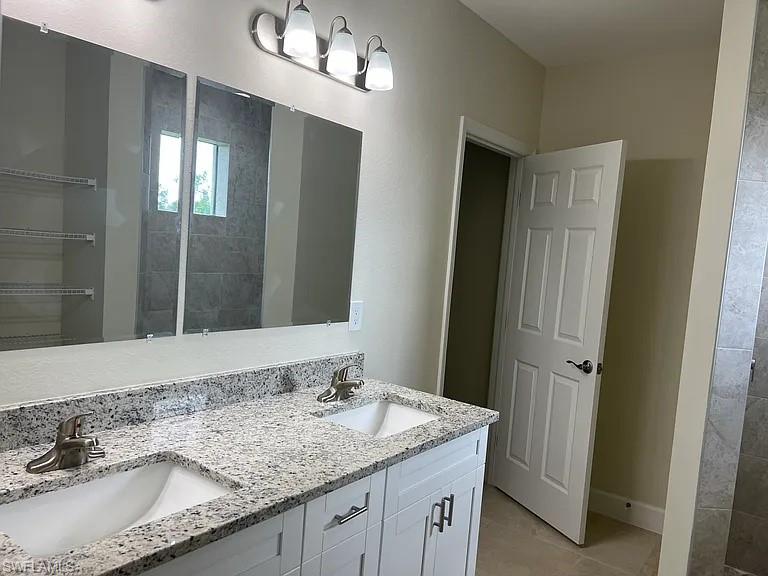 Dual vanity with integrated sinks, brushed nickel fixtures, and a speckled countertop