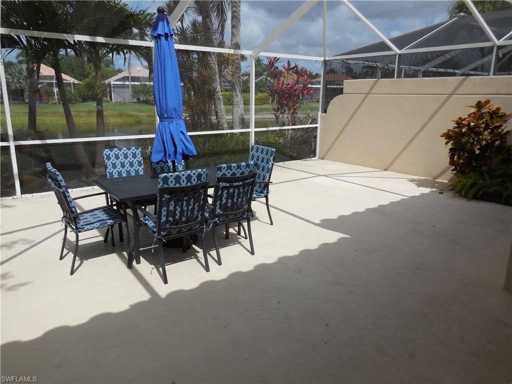 View of patio / terrace featuring a lanai and outdoor dining space
