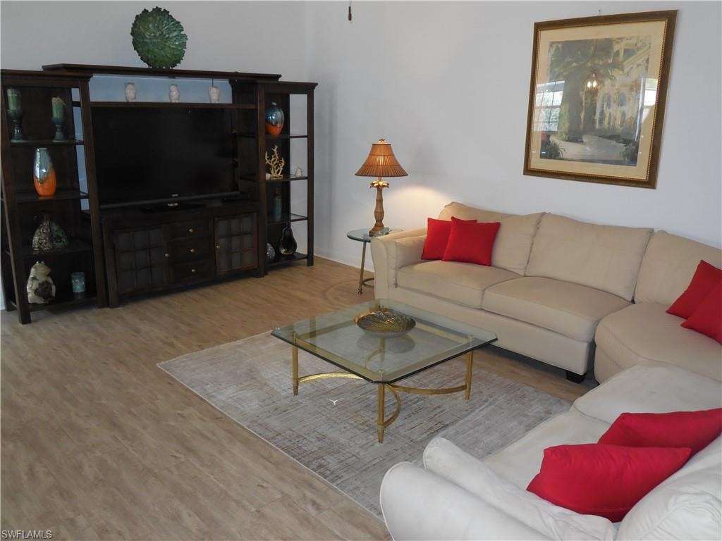 Living area with baseboards and wood finished floors