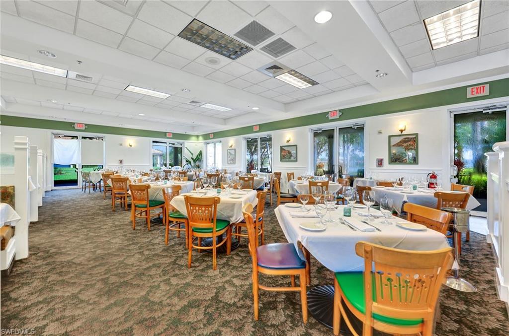 Carpeted dining space with a drop ceiling and a healthy amount of sunlight