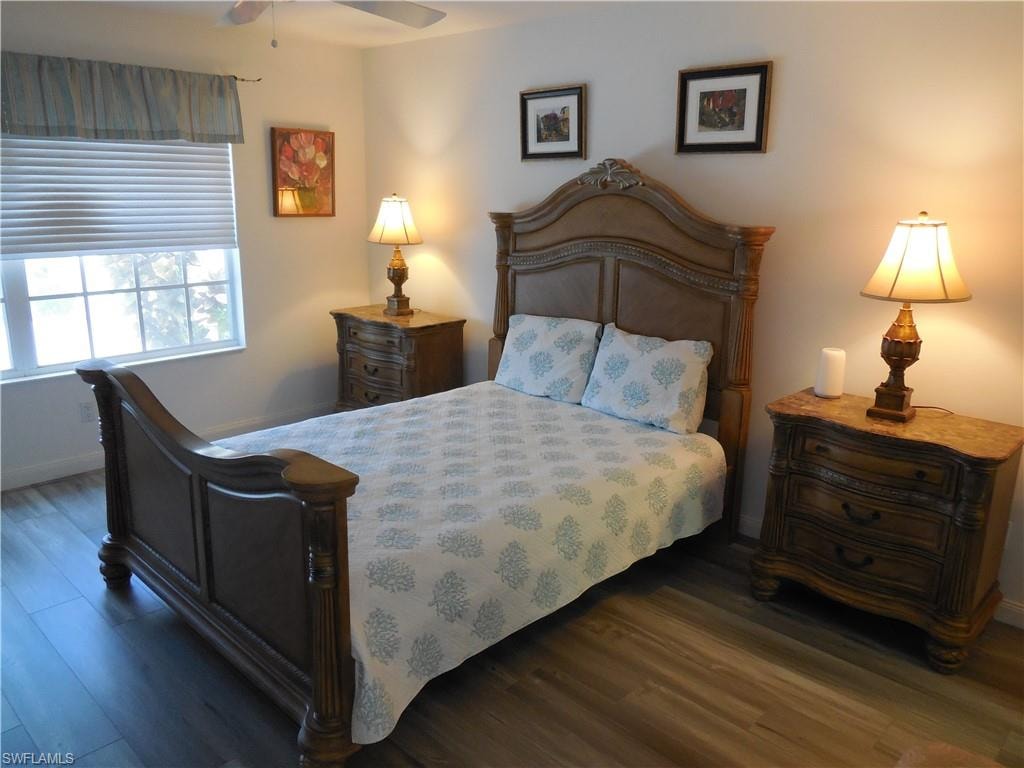 Bedroom with baseboards and wood finished floors