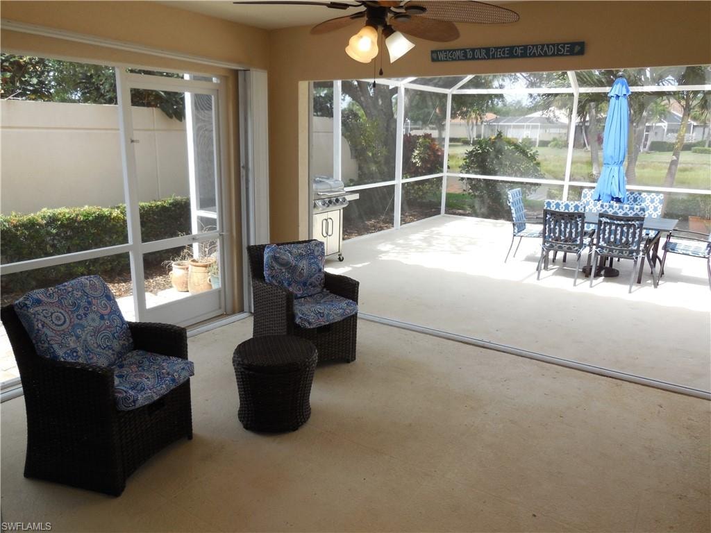 Sunroom featuring ceiling fan and a wealth of natural light