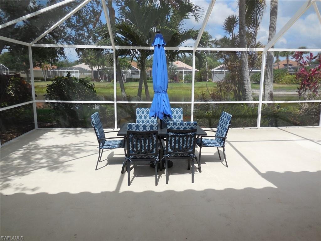 View of patio with a lanai and outdoor dining space