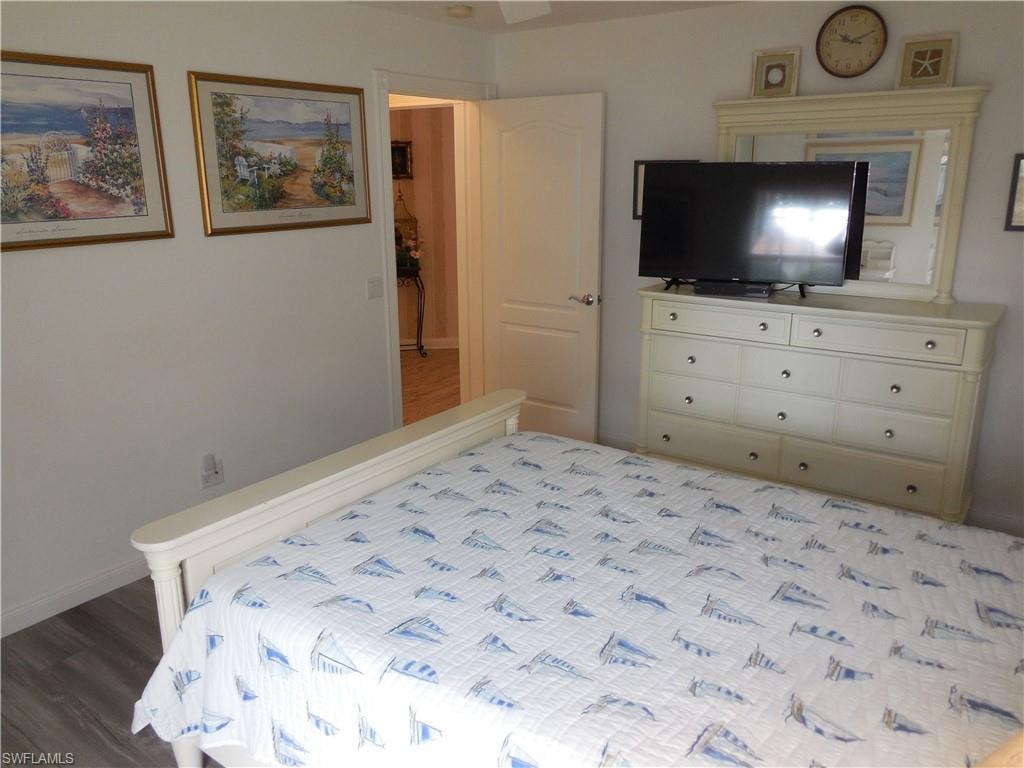 Bedroom with baseboards and wood finished floors