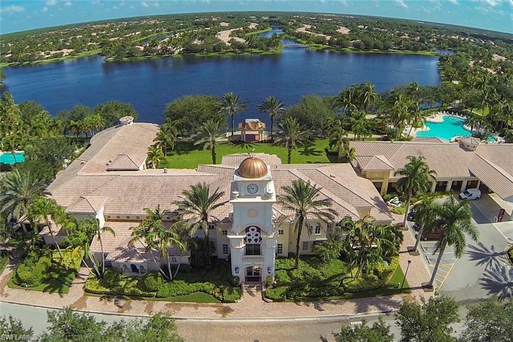 Birds eye view of property with a water view