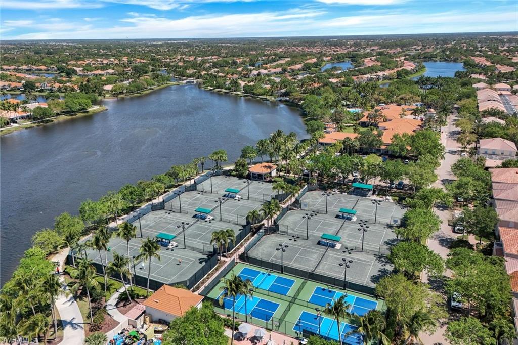 Birds eye view of property with a water view and a residential view