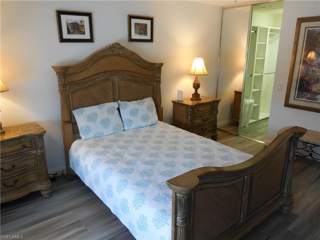 Bedroom with baseboards and wood finished floors