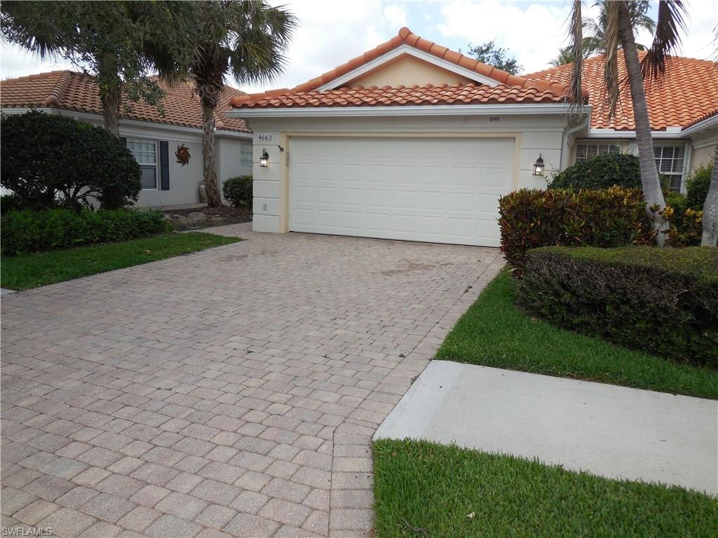 Mediterranean / spanish home with decorative driveway, an attached garage, a tile roof, and stucco siding