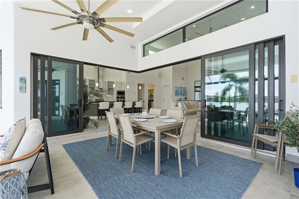 View looking into home of covered outdoor dining/seating area