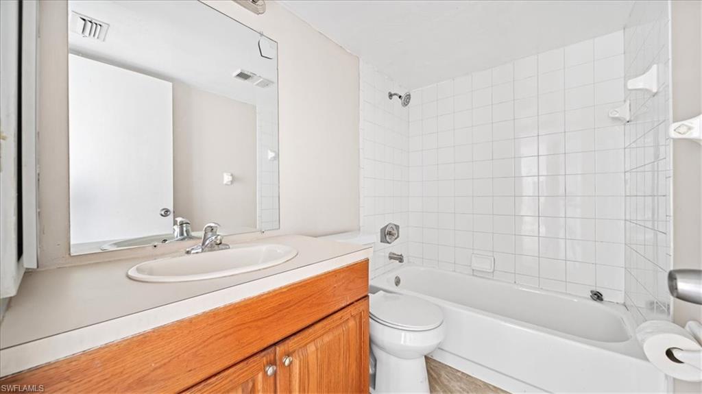 Wood-finish vanity with an integrated sink and chrome faucet
