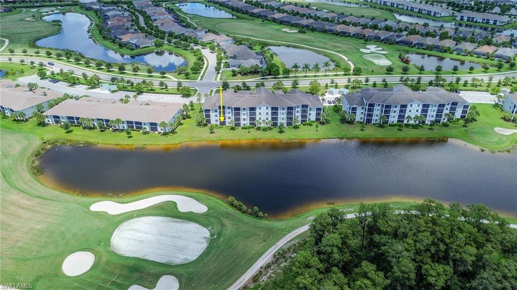 Waterfront property with golf course access, surrounded by green spaces and residential buildings