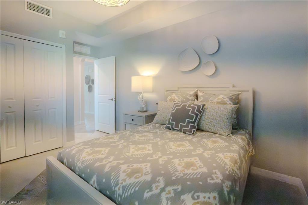 Recessed lighting, light-colored walls, white paneled bifold closet doors, and white paneled interior doors