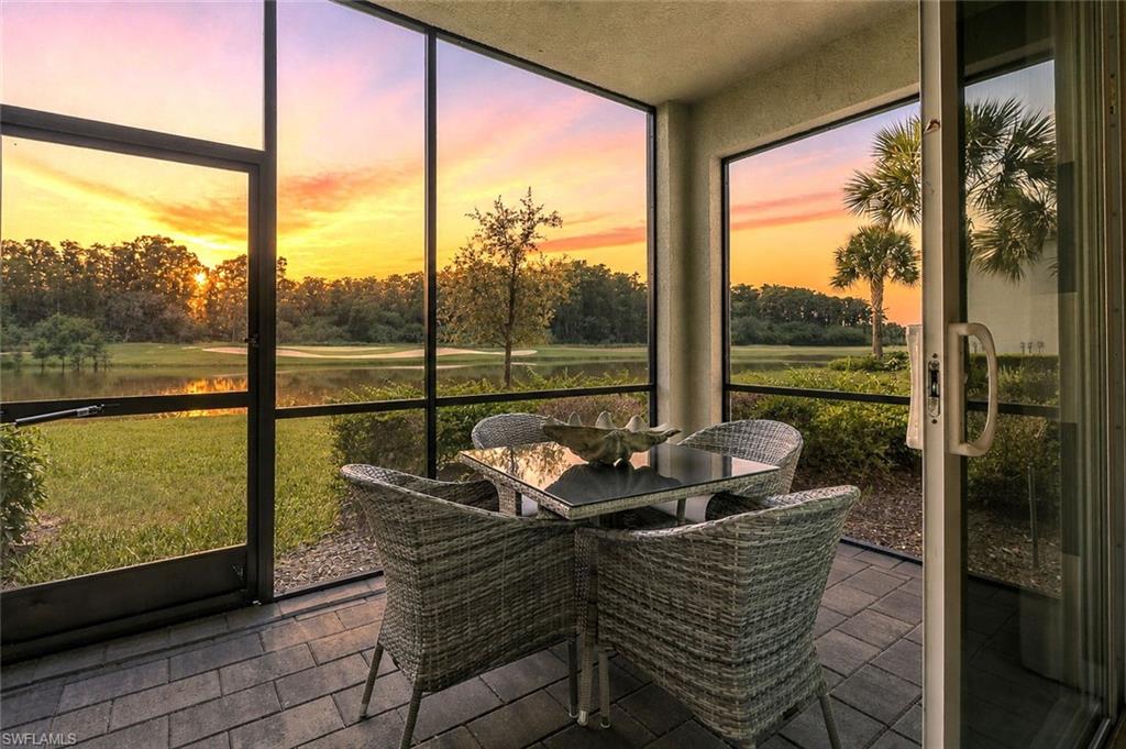 Screened patio featuring paver flooring, a sliding glass door, and a tranquil water feature