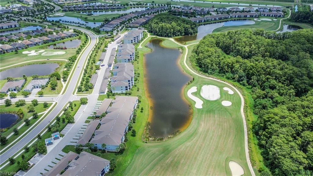 Expansive golf course and water features, surrounded by residential buildings and established green spaces