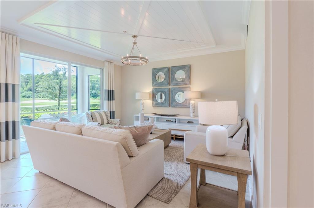 Expansive sliding glass doors, coffered ceiling with shiplap detailing, recessed lighting, and tile flooring