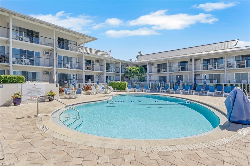 Outdoor swimming pool with integrated steps, surrounded by a paved patio