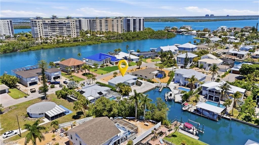 Aerial view of the property, located on a canal with direct water access - Virtually Edited Image
