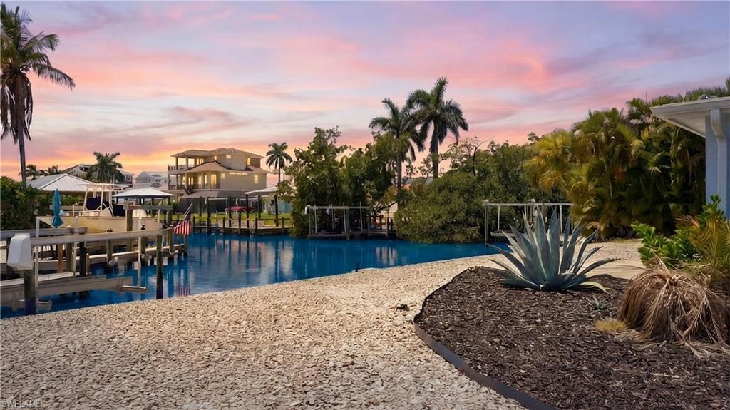 The property features a waterfront location with a private dock - Virtually Edited Image