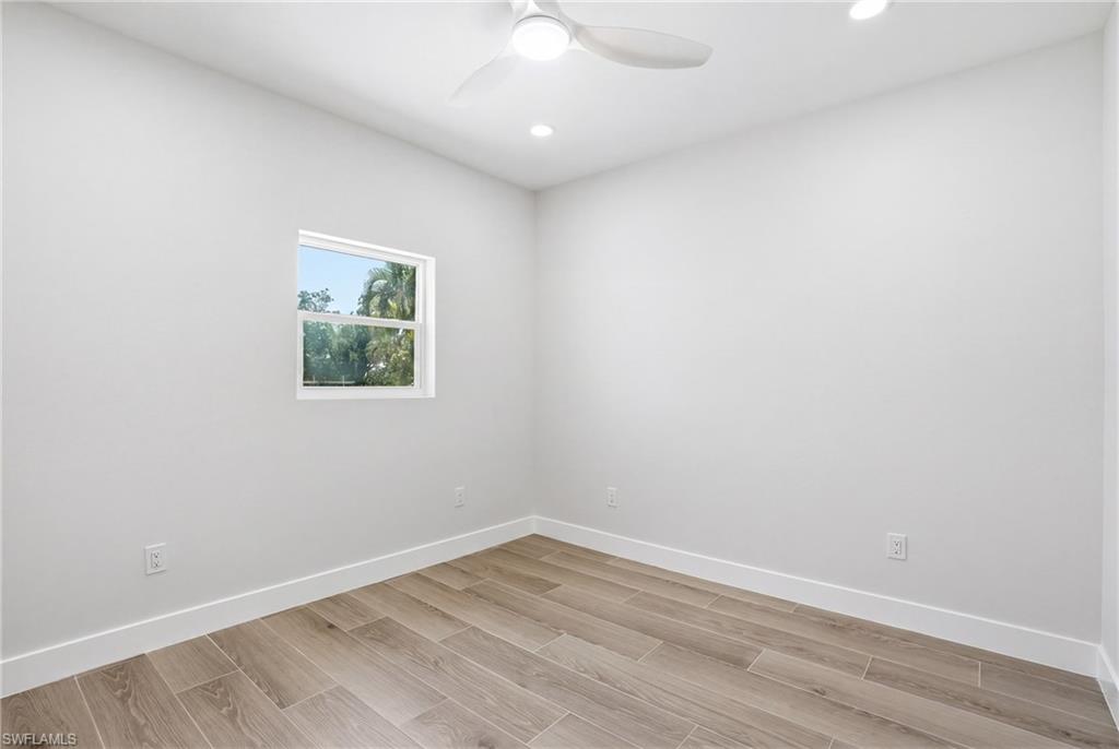 The room features light wood-look flooring and a window providing natural light