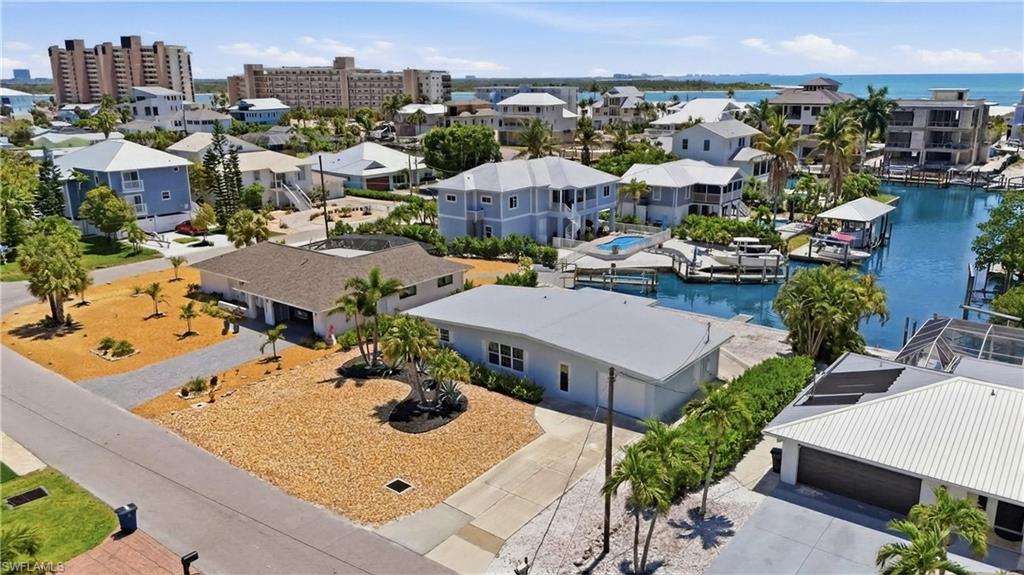 This property features a single-story structure with a light-colored roof and an attached garage - Virtually Edited Image