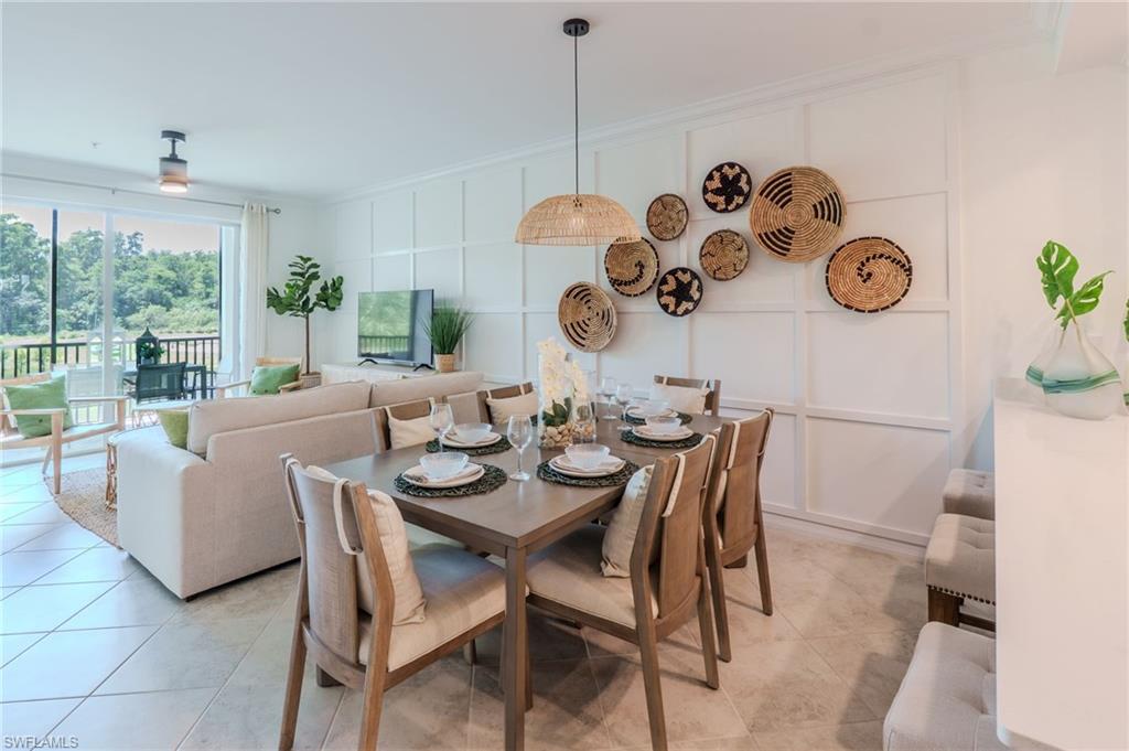 Open-concept living area with tile flooring, a dining space featuring a woven pendant light, and a living area with a ceiling fan