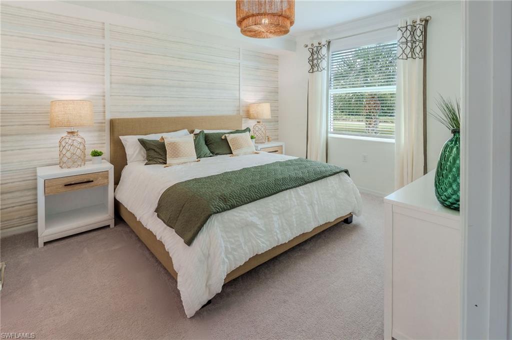 Wall-to-wall carpeting, window with blinds, decorative light fixture, and two nightstands with drawer storage