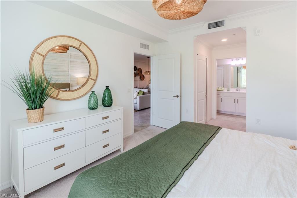 White walls, crown molding, and recessed lighting create a bright interior