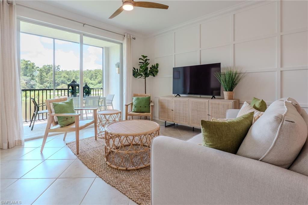 Board and batten accent wall, tile flooring, ceiling fan, and sliding glass doors opening to a screened balcony