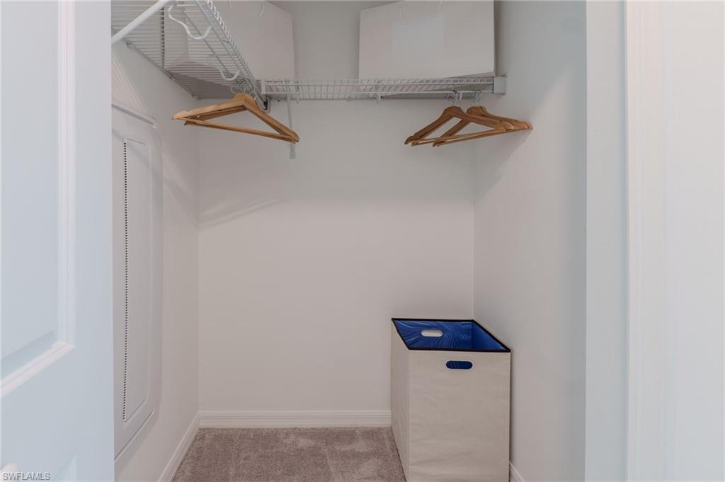 White wire shelving system over carpeted flooring