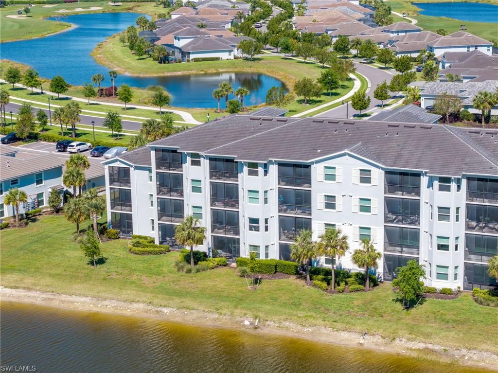 Multi-story building featuring screened balconies and a tile roof