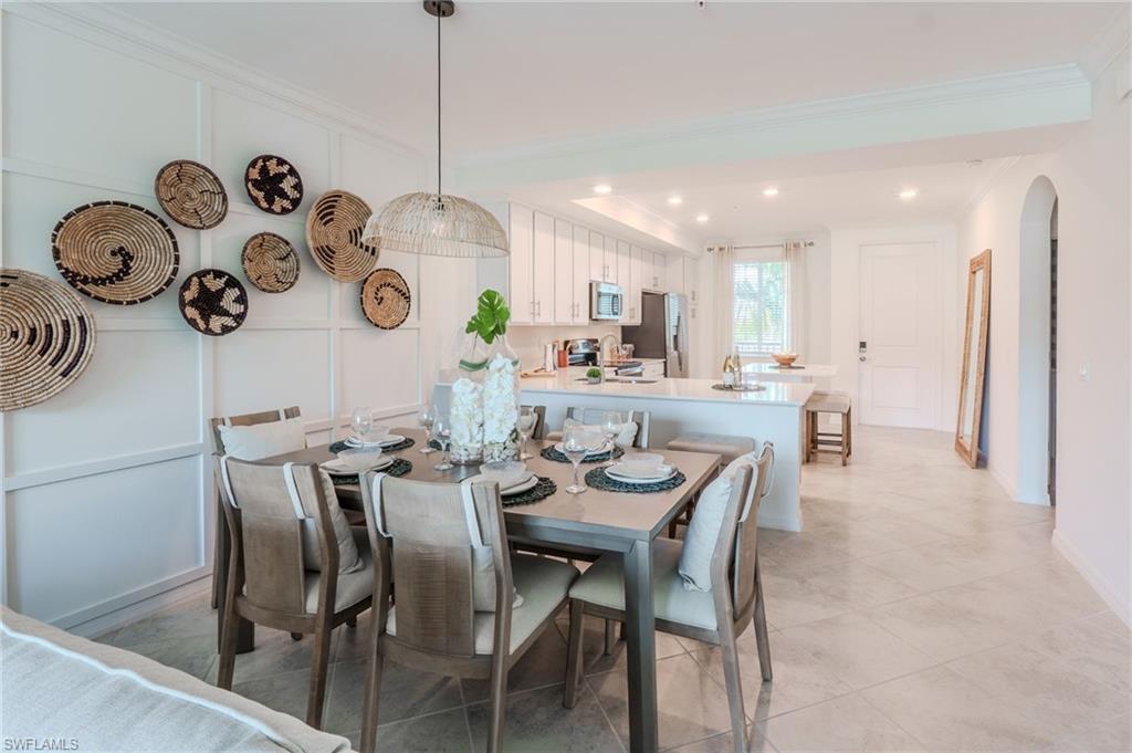 Open-concept living area featuring a kitchen with an island, recessed lighting, and tile flooring