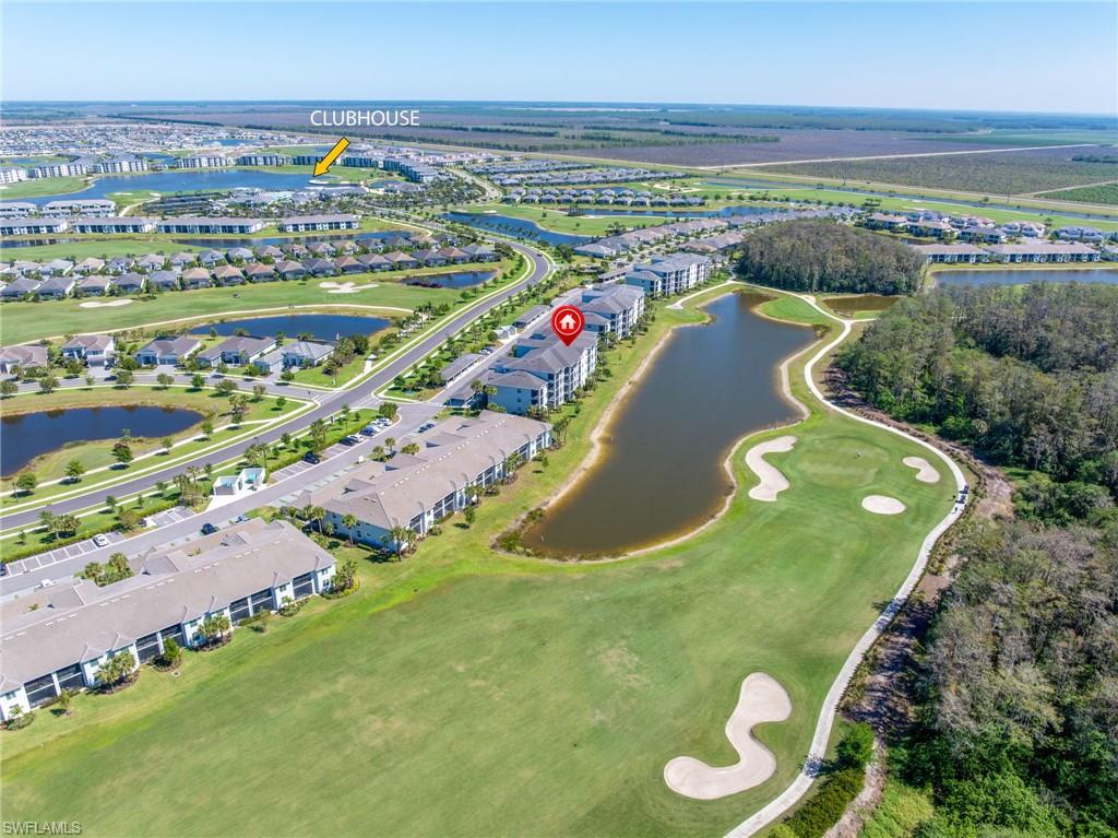 Community featuring multiple bodies of water, golf course, and paved roadways