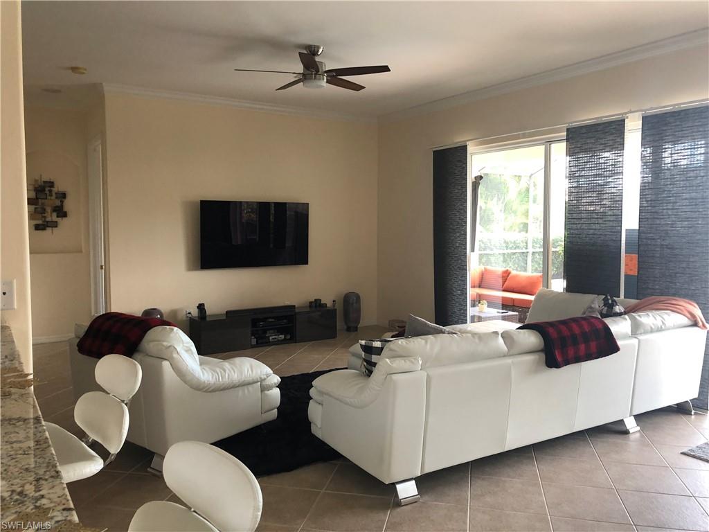 Living room with a 4 door slider wall looking out to the pool. Tiled flooring in main living area. Easy to care for