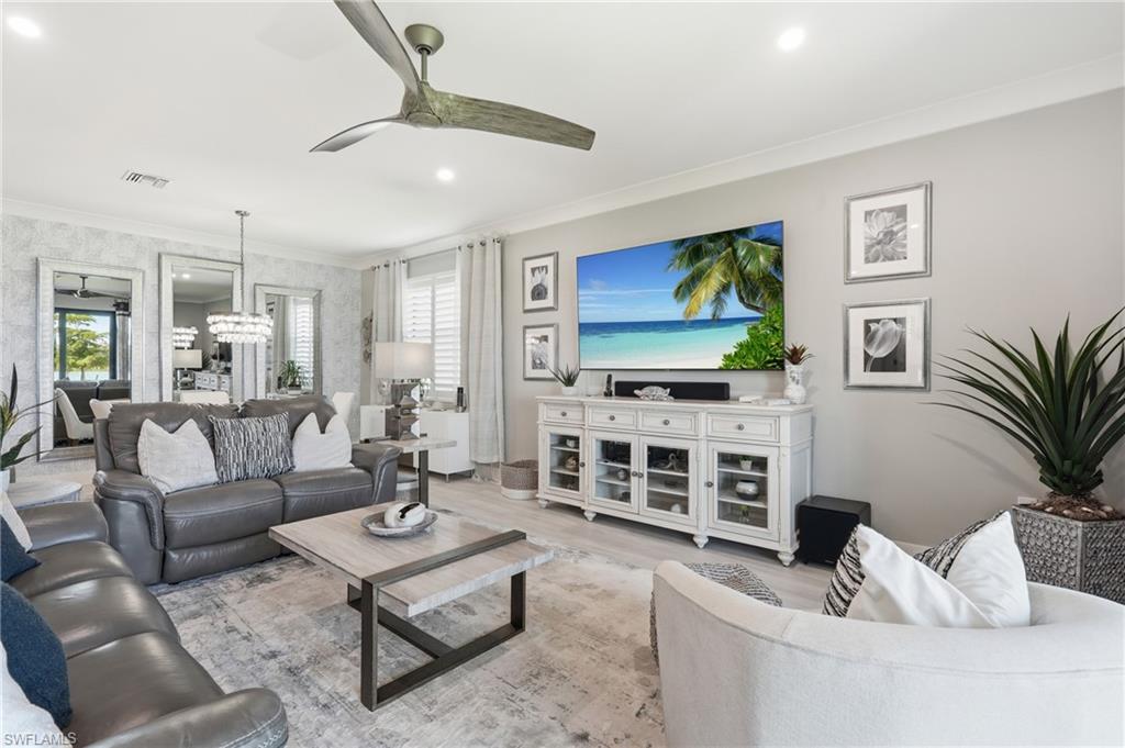 Bright, open-concept living area featuring a ceiling fan, recessed lighting, and neutral wall finishes