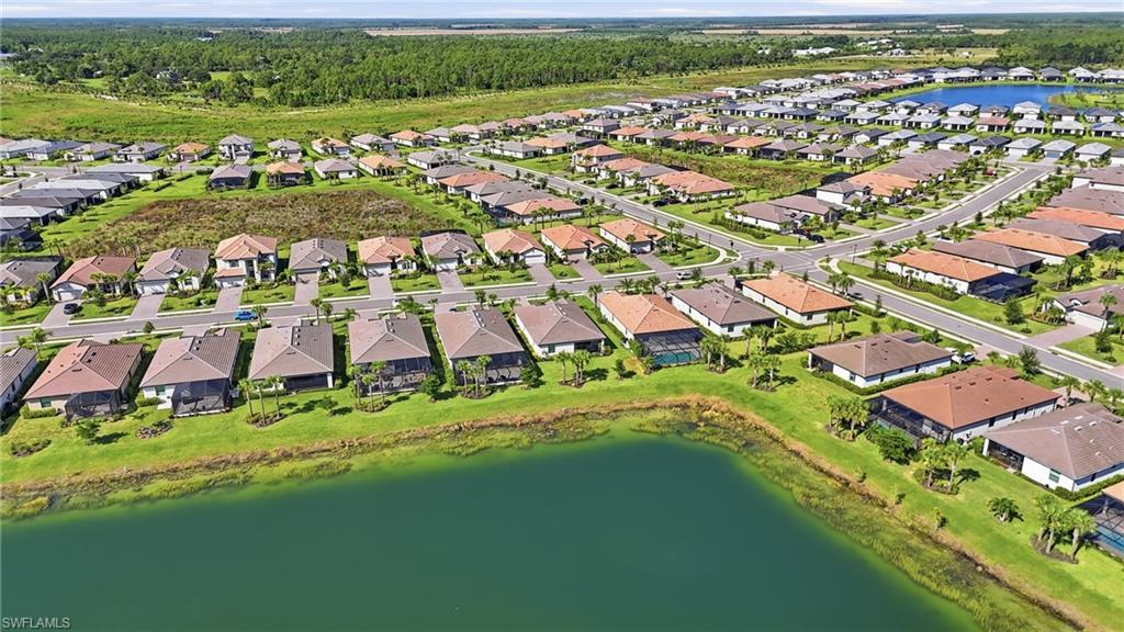 Aerial view of a well-established residential community featuring single-family homes with varied architectural designs and earth-tone roofing