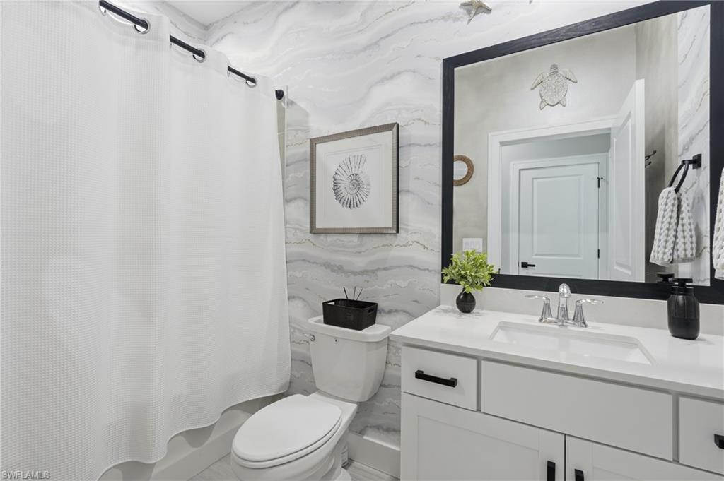 Spa-inspired bathroom featuring a floating vanity with white quartz countertop, polished chrome faucet, and ample storage