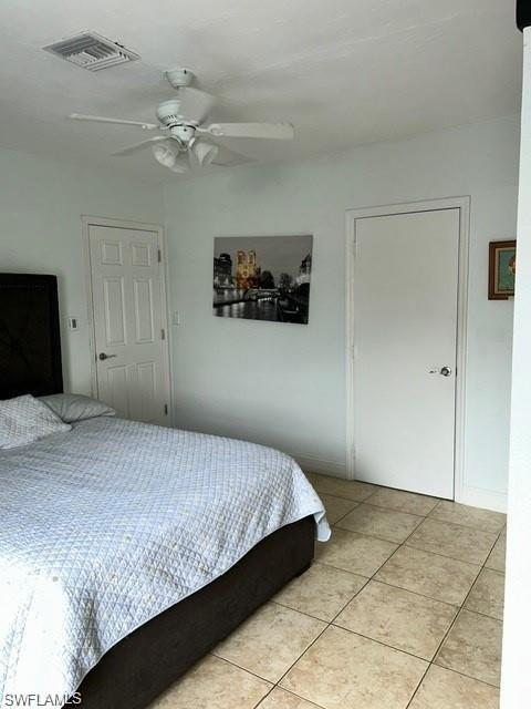 Recessed ceiling fan with integrated lighting, two panel doors, and neutral floor tiling
